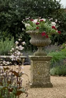 Gravel Gallery: Stone urn with flowers